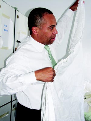 Gov. Deval Patrick folded sheets while he talked with a NOAH shelter client.