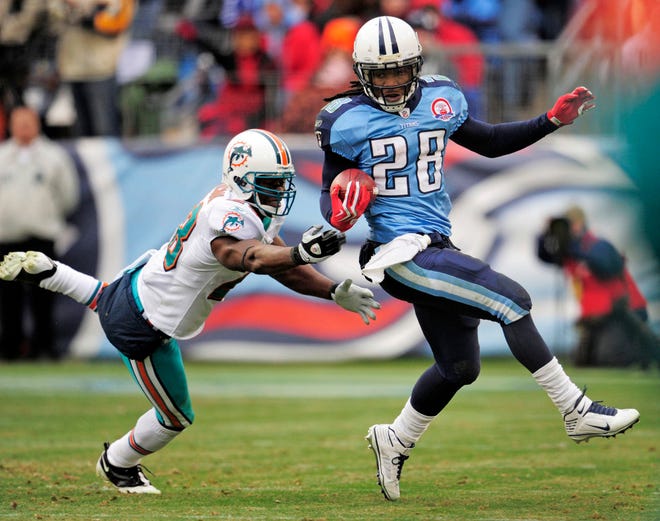 Tennessee Titans running back Chris Johnson (28) gets past Miami Dolphins safety Gibril Wilson in the third quarter of an NFL football game on Sunday, Dec. 20, 2009, in Nashville, Tenn. (AP Photo/John Russell)