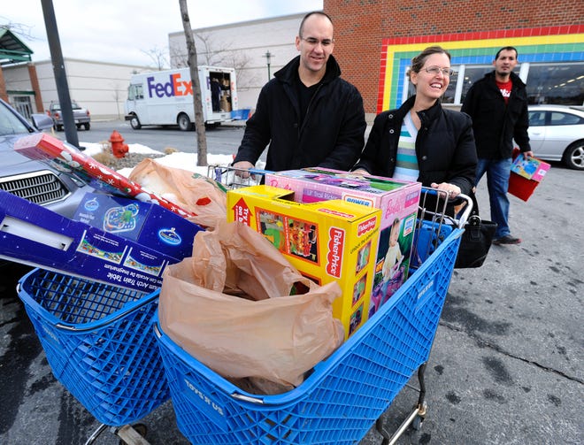 Joe and Lori Horvat of Needham loaded up two shopping carts with toys yesterday at Toys R Us at Shoppers World in Framingham as they did their Christmas shopping on Christmas Eve.