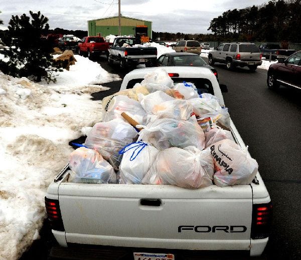A Mashpee driver waits in line to dump the holiday trash of Mashpee relatives at the town's transfer station yesterday.