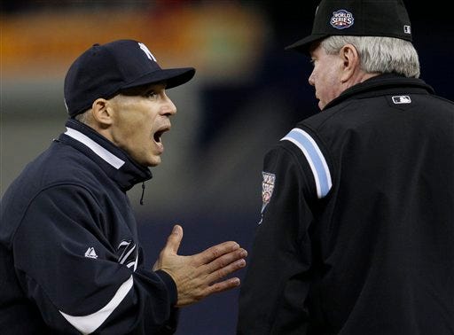 New York Yankees manager Joe Girardi, left, argues with first base umpire Brian Gorman after Philadelphia Phillies' Ryan Howard turned a double play on a ball hit by New York Yankees' Johnny Damon during the seventh inning of Game 2 of the Major League Baseball World Series Thursday, Oct. 29, 2009, in New York.