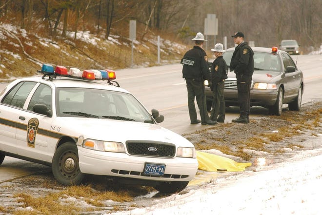 State police monitor the scene on Interstate 380 northbound at the site where at least one bag containing body parts was found on Tuesday, Jan. 29, 2008.