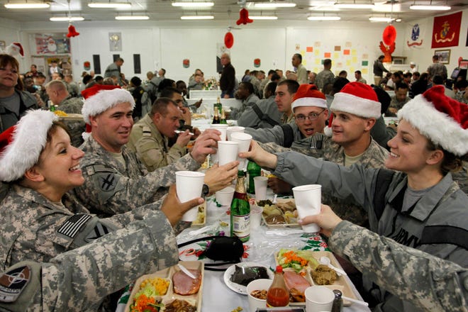 Musadeq Sadeq/The Associated Press
U.S. soldiers, among the thousands currently serving overseas, toast each other during their lunch meal on Christmas Day at Camp Phoenix in Kabul, Afghanistan. (AP Photo/Musadeq Sadeq)