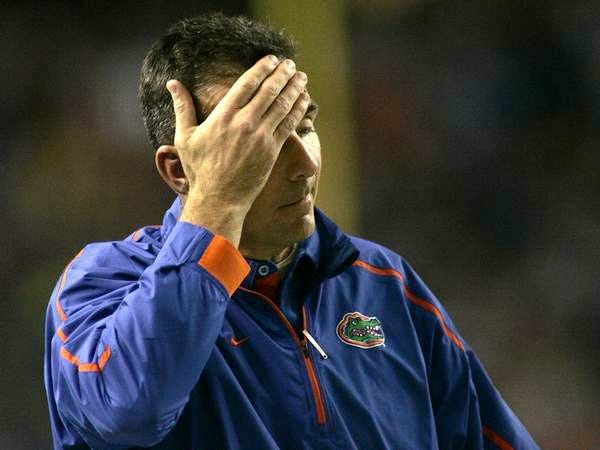 Florida head coach Urban Meyer wipes his brow after a negative Florida play during the first half of the SEC Championship Game on Dec. 5.