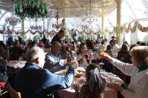 Seated at the table in the foreground, from left, Hermann Schulz, his son-in-law Tim Holz, his daughter LIsa Holz, his granddaughter Erika Holz, 7, his wife Carol Schulz, and his granddaughter Kalya Holz, 4, toast as they dine in the Crystal Room at Tavern on the Green in New York, Tuesday Dec. 29, 2009. The restaurant is scheduled to serve its last meal on Dec. 31.
