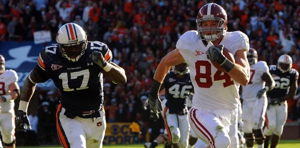Alabama tight end Colin Peek (84) outruns Auburn linebacker Josh Bynes (17) to the end zone on a touchdown reception during the second quarter of college football action at Jordan-Hare Stadium in Auburn, Ala., Friday, Nov. 27, 2009.