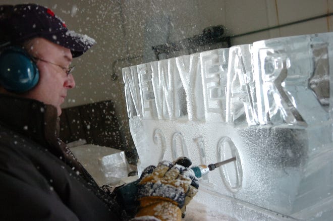 Craig McConnell, owner of Images in Ice in Brockton, works on an ice sculpture for a private New Year's Eve party at his rented space inside the large walk-in freezer at Eastern Ice Co. in Brockton.