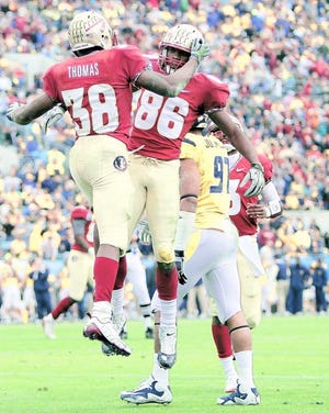 Florida State's Darren Edwards (left) celebrates with Rod Owens (right) after scoring a touchdown during the first half. By DARON DEAN, daron.dean@staugustine.com