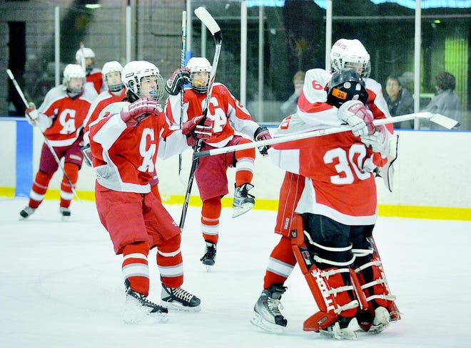 Canandaigua players mob goalie Nicholas Dilg (30) following Saturday afternoon's 2-1 win over Gates Chili at Genesee Valley Ice Arena (01/02/10).