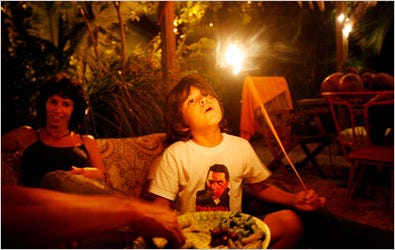 Diego Montoya, 6, above, and his mother, Rosario, sitting near an outdoor fire pit made by his father.