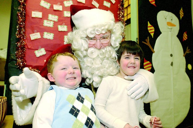 Connor Gordon, 3, of Greece, and his cousin Max Conge, 4, of Henrietta, pose for a photo with Santa, Peter Madalenna of Irondequoit, a member of the Kiwanis Club of Irondequoit.
