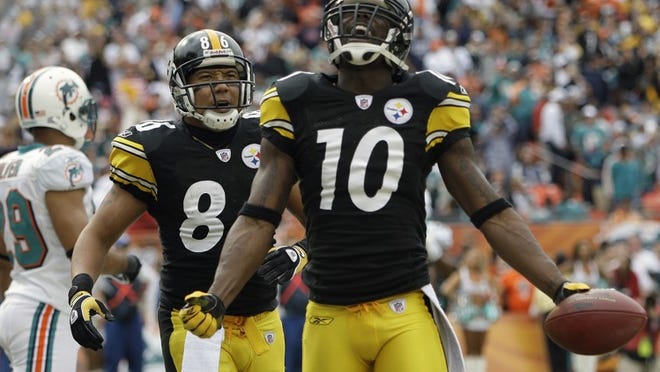 Pittsburgh's Santonio Holmes (10), a former Glades Central standout, celebrates a touchdown with wide receiver Hines Ward (86).