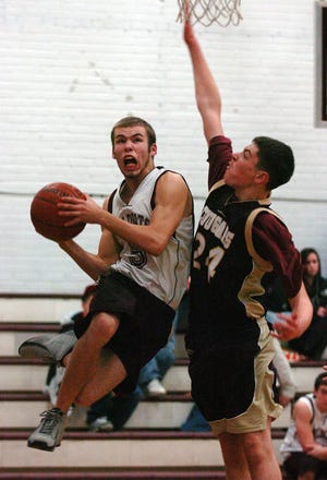 West Bridgewater’s Josh Rucoles drives to the basket against the defense of Old Colony’s Mike Hamel on Monday night. West Bridgewater won, 66-40.