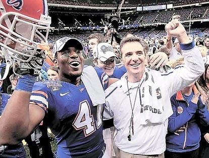 Florida coach Urban Meyer, right, celebrates with players Ryan Stamper, left, and Tim Tebow, center, after a 51-24 win over Cincinnati in the Sugar Bowl on Friday in New Orleans. By BILL HABER, The Associated Press