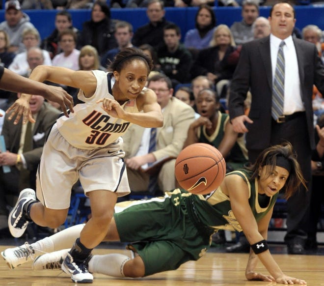 Connecticut's Lorin Dixon, left, pursues a lose ball after fouling South Florida's Jasmine Wynn, right, in the first half of a women's NCAA college basketball game in Hartford, Conn., Monday, Jan. 4, 2010.