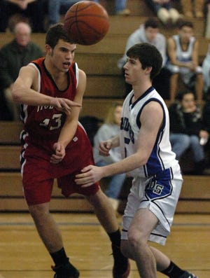 DOVER - Holliston's Mike Ritter passes against Dover-Sherborn's Connor Moriarty, Tuesday in Dover.