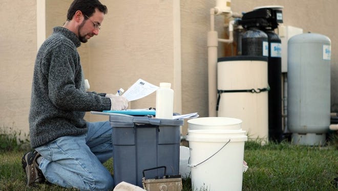 ACREAGE, FL Drew Campbell, environmental services manager for Milian, Swain & Associates documents water tests from a filtration system at a home in the Acreage. The law firm of Weitz and Luxenberg is testing the water at 10 homes comparing the filtered water with unfiltered water directly from the well.