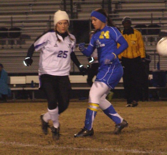 Dutchtown’s Lindi Robichaux passes downfield ahead of East Ascension’s Kristen Simoneaux in the first half of the Lady Griffins’ 6-0 District 6-I victory Tuesday night at Griffin Field. Robichaux led Dutchtown with two goals.