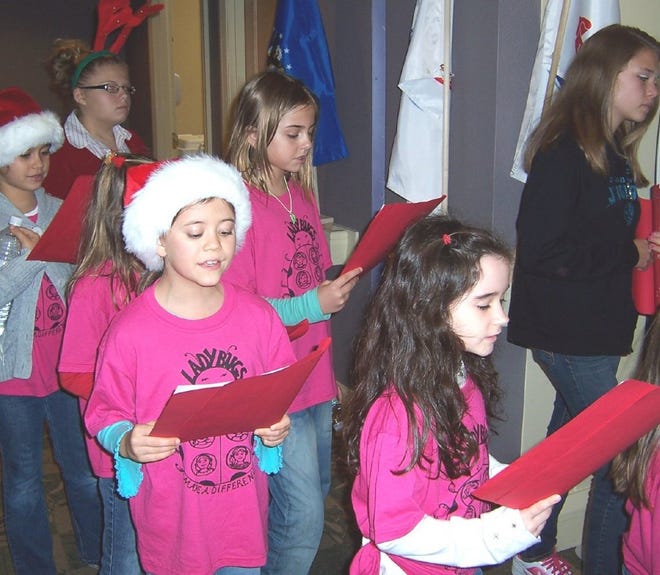 Community HospiceLadybugs members stopped at hospice patients' rooms and staff offices to sing holiday carols.