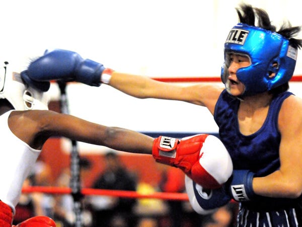 Talon Caravalho of Wilmington (in blue) throws a right against Zimmie Dickson of Washington, D.C., during the 12/13 year old-80lbs weight division during the 2010 Regional Silver Gloves Championships on Saturday evening at the National Guard Armory. After 3 rounds Caranalho was defeated by decision.