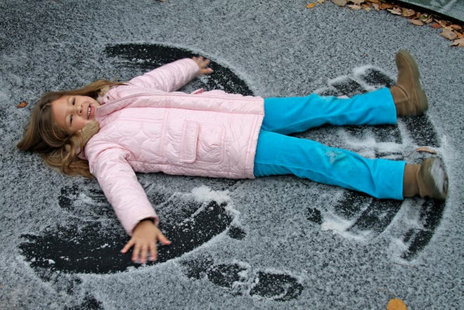 Ava Zacco, 5, made snow angels on her trampoline on Saturday in Ocala after the area received a dusting of snow.