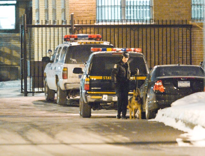 Emergency personnel block off the area Monday, Jan. 11, 2020, surrounding the Utica Police Department after a suspicious package was found near an officer's personal car as he was leaving work at the end of his shift. The New York State Police Bomb Disposal Unit.