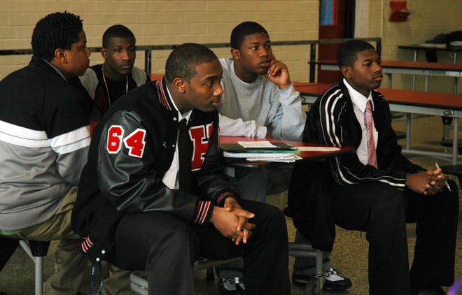 Teens listen to Neely Lovett speak during the Positive Boys, Positive Men club meeting.