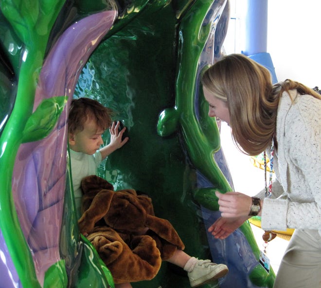 Kaylee Kent, 3, plays in the new indoor playground at the Medical College of Georgia Children's Medical Center as child life specialist Jami Wolfe watches.