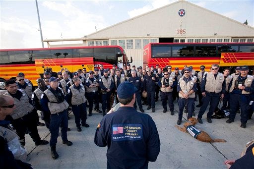Members of the Los Angeles County Fire Department's Task Force 2 Search and Rescue team have a meeting to prepare to leave for Haiti to help in that country's devastating earthquake at the March Air Reserve Base in Moreno Valley, Calif., on Wednesday, Jan. 13, 2010.
