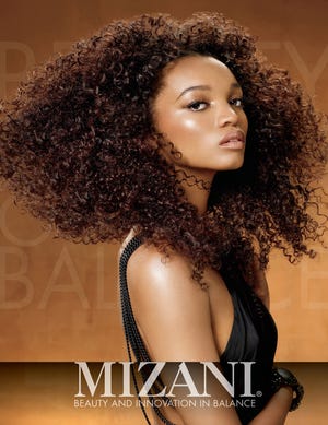 A Type IV model on the Mizani Natural Curl Key- Curly mixed curls patterns spiral and ringlets.
