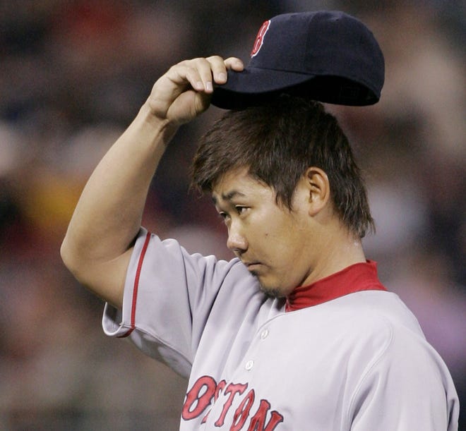 Boston Red Sox' pitcher Daisuke Matsuzaka takes off his cap during a gave against the Minnesota Twins in May 2008, in Minneapolis.