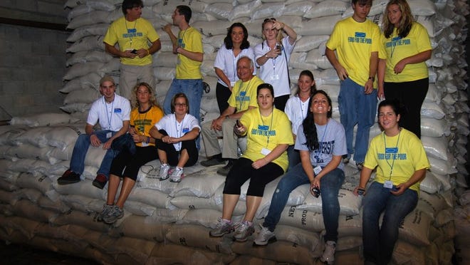 The Journey for Hope group at the Food for the Poor Haiti Warehouse and Feeding Center in Port-au-Prince. In the front, sitting: Paul Tyska, Lindsay Doran, Nikki Fantauzzi, Richard Bruno, Christine Gianacaci, Daniela Montealegre, Britney Gengel and Stephanie Crispinelli. In the back row,standing: Patrick Hartwick, Michael DeMatteo, Courtney Hayes, Julie Prudhomme, Thomas Schloemer and Melissa Elliott.