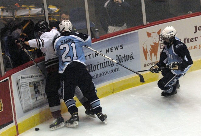 The Citadel's Phil Warner,21, and South Carolina's Karl Wiant battle along the wall during Thursday night's exhibition game in the Savannah Tire Hockey Classic at the Savannah Civic Center.