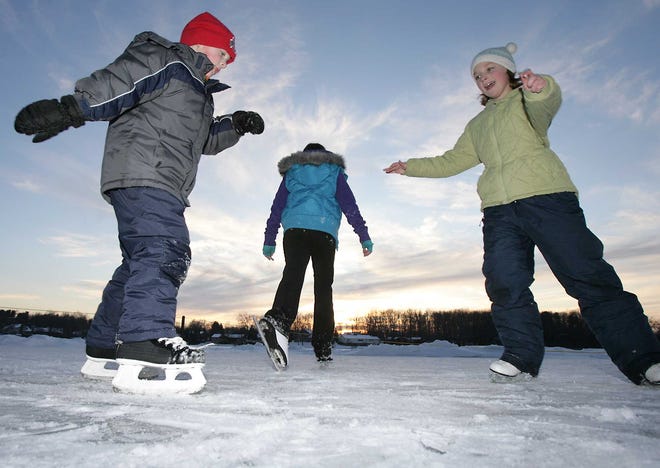 Left to right, Griffin Barnett, Madison Hostetler and Cassidy Barnett skate on the frozen Sippo Lake on Thursday.