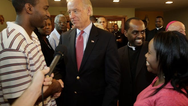 Vice President Joe Biden meets with Pierre Lascaze, left, and Dolina Lordeus Lascaze, right, as he visits members of the Haitian-American community at the Notre Dame D'Haiti Roman Catholic Church in Miami on Saturday, Jan. 16, 2010.