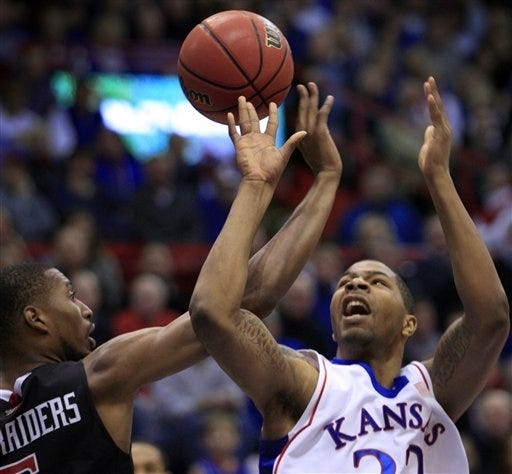 Kansas forward Marcus Morris (22) and Texas Tech forward D'walyn Roberts (5) battle for a rebound. Morris won the battle and the war, getting a team-high 20 points and eight rebounds in KU's 89-63 win Saturday at Allen Fieldhouse.