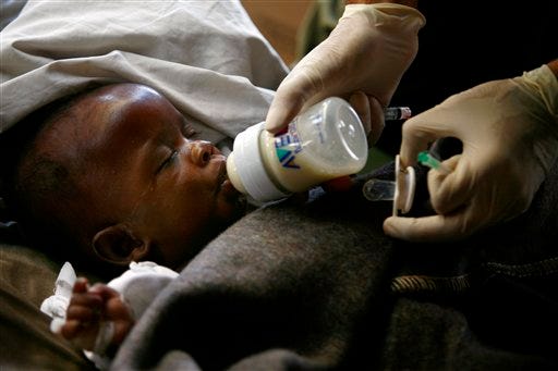 A nurse feeds a quake-injured baby at the Israeli Field Hospital in Port-au-Prince, Monday, Jan. 18, 2010.