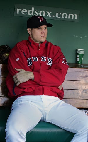 Jonathan Papelbon sits in the Red Sox' dugout after imploding in the ninth inning during Game 3 of the ALDS against the Angels.