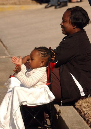 TERRY DICKSON/The Times-UnionCarlie White claps as she watches the Martin Luther King Day parade in Waycross with her grandmother, Cheryl Kennedy.