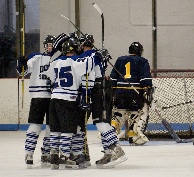 The Dover-Sherborn hockey team celebrates a goal by Jeff Williams during its 5-3 win over Marian.