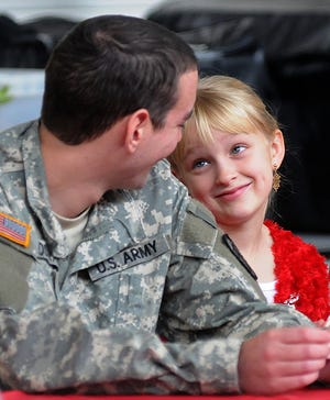 U.S. Army National Guard Spec. Marty Oswald talks with his neice, Kelly Oswald of Machesney Park, during Freeport’s 333rd Illinois National Guard Military Police Unit's annual Christmas dinner at the National Guard armory.