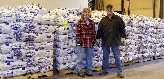 Kathleen Terry with truck driver Ken Hayes from Northern Maine after they unloaded the 50,000 pounds of potatoes at the Wayne County Food Pantry in Honesdale.