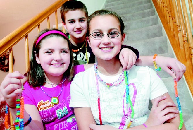 Gabriella Lexer 10, right, and her friend Shelbie Clancy 11, make and sell jewelry to benefit cancer treatment centers. Lexer's brother John, 9, helps out.