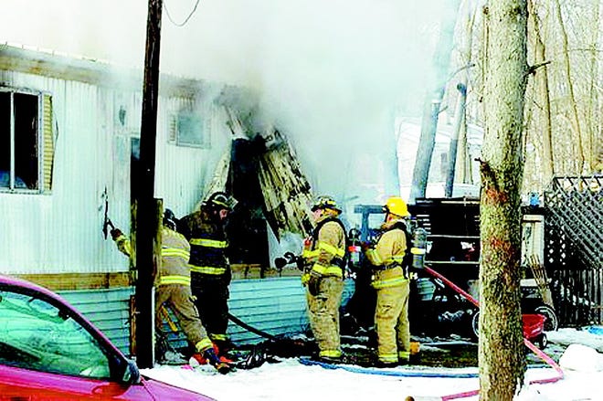 Firefighters from Sherwood, Athens and Union City battle a mobile home fire on Thursday morning in Sherwood Township.