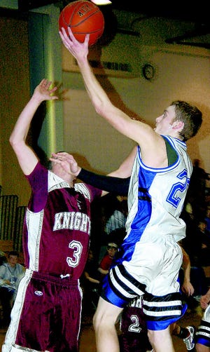 Dolgeville’s Ryan Barton goes up for a layup in the third quarter with Mike Tomaino (left) defending for Frankfort-Schuyler. The basket gave Dolgeville a 52-51 lead. Barton later put Dolgeville ahead to stay with a three-pointer in the fourth quarter.