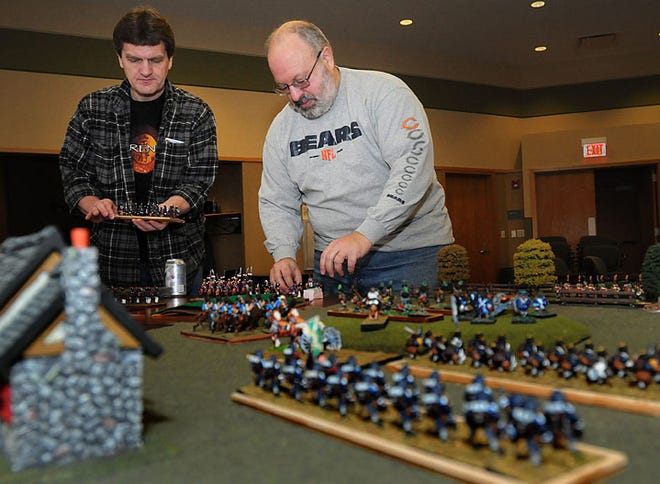 Ron Plosch of Freeport (left) and Rick Lindenmeyer of Freeport (right) set up the pieces for the Napoleanic game Slaughterloo Friday during FreeCon III Wargaming at Freeport Public Library.