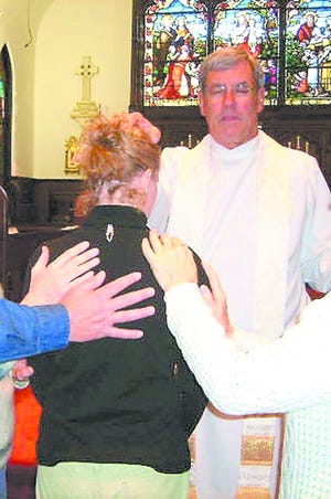 Laying on of hands during a Trinity Episcopal healing service. Contributed photos.