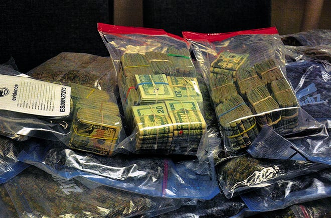 DEA task force and special agents and Raynham detectives came away with this haul of marijuana and cash confiscated Wednesday from a Raynham house.