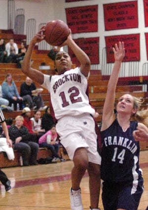 From left Brockton's Tianna Johnson drives to the basket. The Franklin defender is Taylor Kale.
