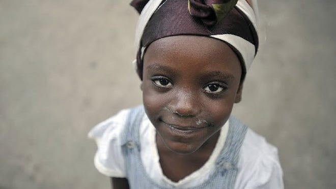 A little girl flashes a smile at Park Boyer, in Petionville, Haiti, Saturday, January 16, 2009.